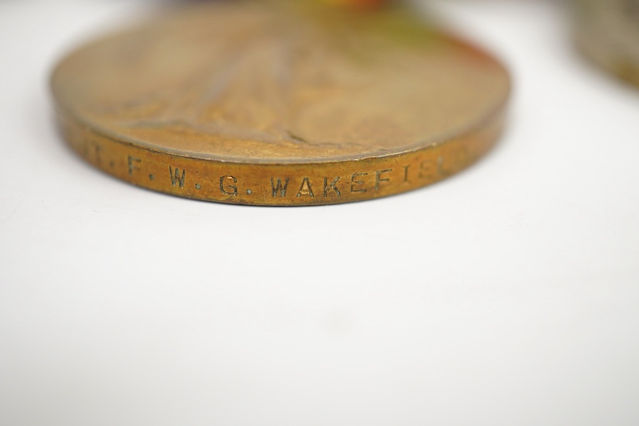 A medal group comprising of a Meritorious Service medal, a 1939 to 1945 Defence Medal, and a First World War trio awarded to 3824 SJT. F.W.G. Wakefield. R.F.A., together with a Delhi Durbar Medal 1911, crudely engraved t